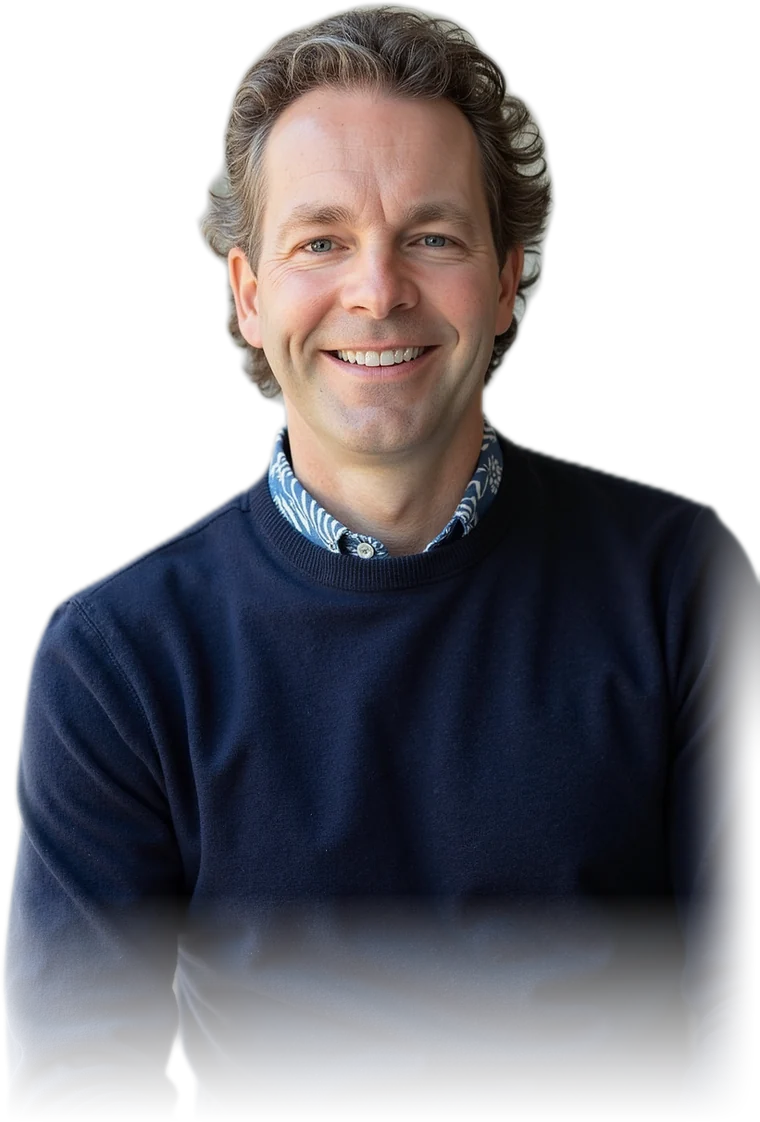 Tom Mawhinney smiling in a navy sweater